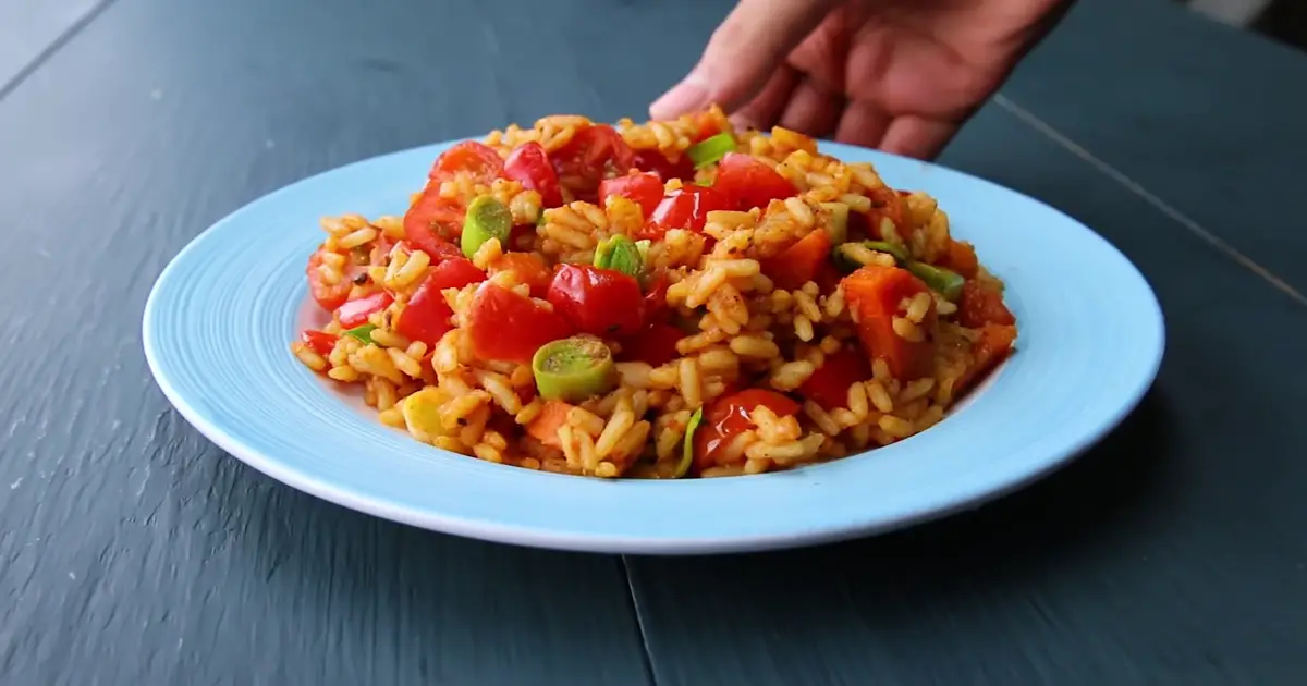 A plate of healthy veggie fried rice with carrots, bell peppers, and cilantro